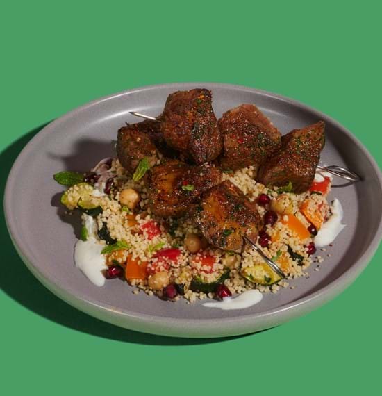 Moroccan-Style Kebabs Moroccan-style kebabs plated on top of couscous salad