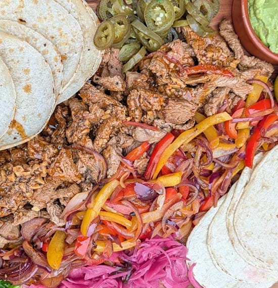Steak and Lamb Fajita Sharing Platter A sharing platter with Mexican-style fajitas and sides